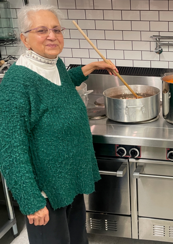 Rani in the kitchen at the Efree church stirring a pot.